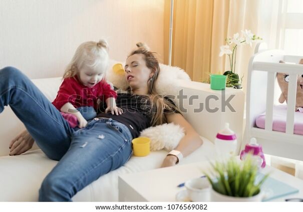 tired-mom-sleeping-600w-1076569082.jpg