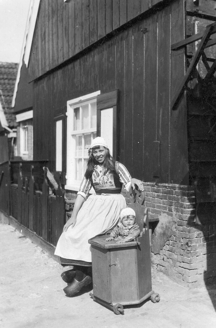 Young Dutch Mother With Her Baby In A Wooden Pram. Netherlands, 1929