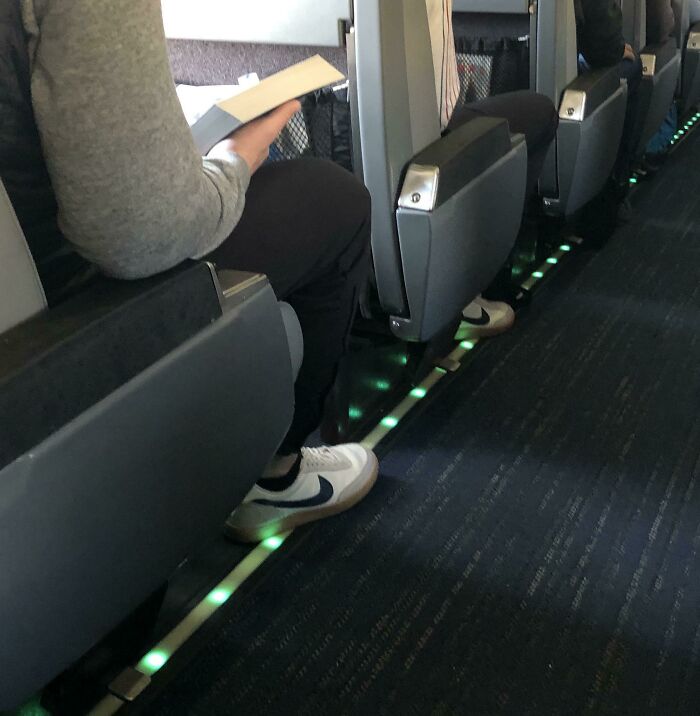 These Two Train Riders With The Same Shoes Facing The Same Way