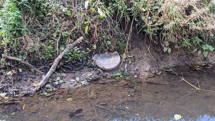 Round, Metallic Looking Piece, Halfway Stuck In The Ground, Placed In West Germany. Was Afraid To Get Closer. Explosive? I Called The Police. They Cleared The Area And Send Me Away