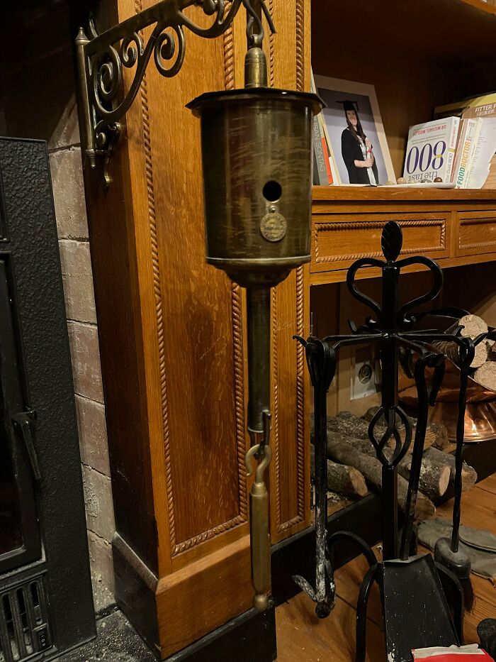 What Is This Thing Hanging Outside My Fireplace. It Seems To Have Gears Inside Of It, And Pivots Into The Fireplace