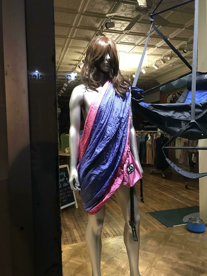 This Mannequin In An Outdoor Supply Store Wearing A Wig And A Hammock - I Can’t Decide Which Accessory I Like More