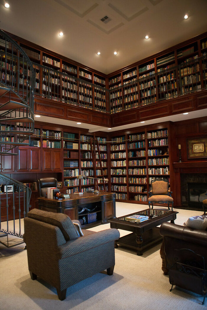 Double-Height Home Office Library With A Fire Place