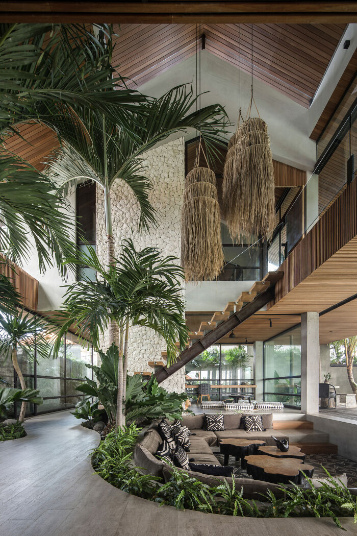 Sunken Living Room Under A High Vaulted Ceiling Surrounded By The Tropical Greenery Of Bali, Indonesia 