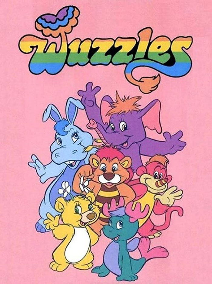 Colorful '80s cartoon characters from Wuzzles on a pink background.