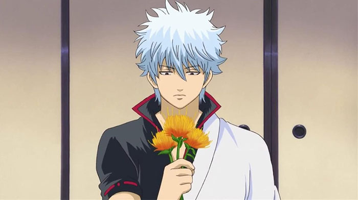 Gintoki Sakata holding orange flowers 