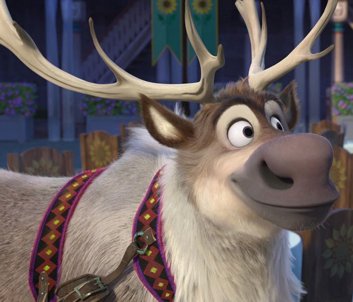A cute animated reindeer character with large antlers and an expressive face, wearing a colorful harness.
