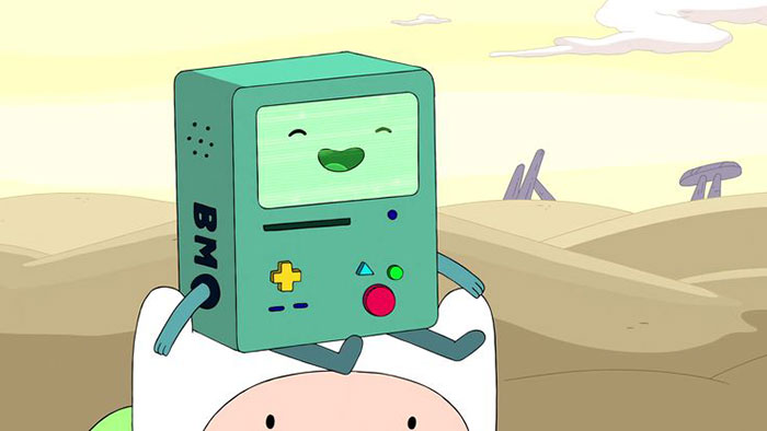 Cute animated character BMO smiling in a desert landscape, sitting on a white hat.