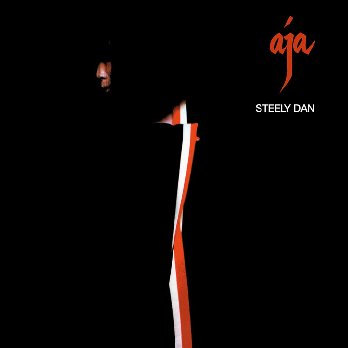 Steely Dan's "Aja" album cover with a minimalist black and red design.