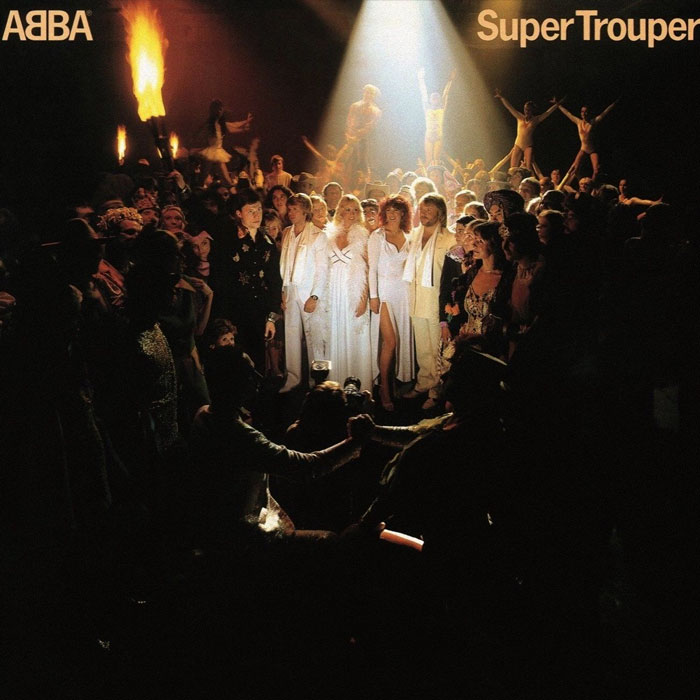 ABBA's "Super Trouper" album cover with the band in spotlight surrounded by a large crowd.
