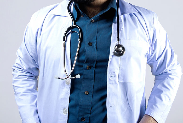 A doctor wearing stethoscope and medical coat