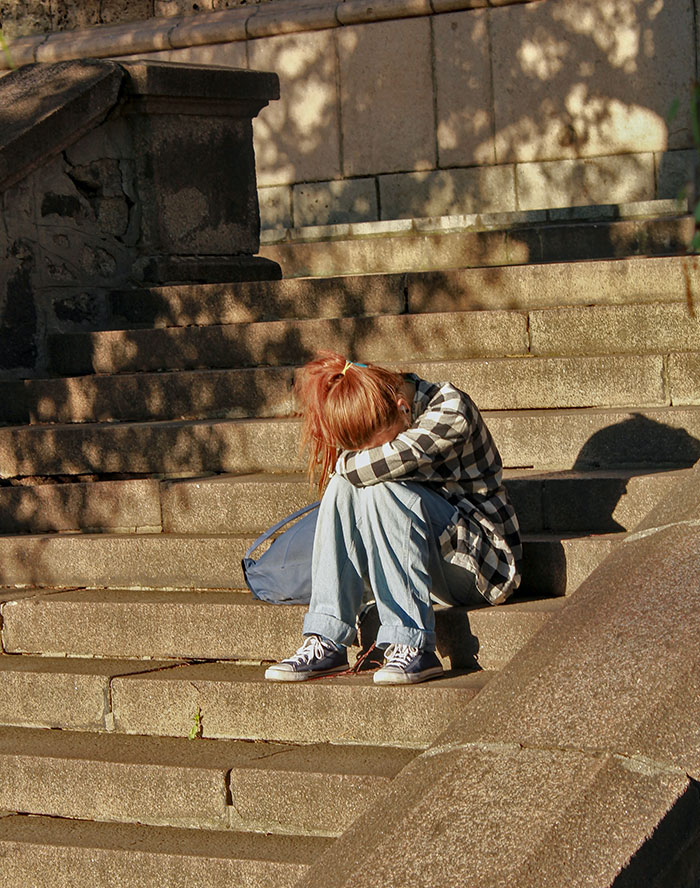 Woman sitting on concrete stairs 