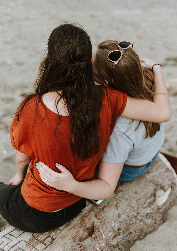 Two womens hugging each other