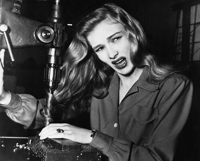 American Film Actress Veronica Lake Illustrates What Can Happen To Women War Workers Who Wear Their Hair Long While Working At Their Benches, In A Factory Somewhere In America, On November 9, 1943