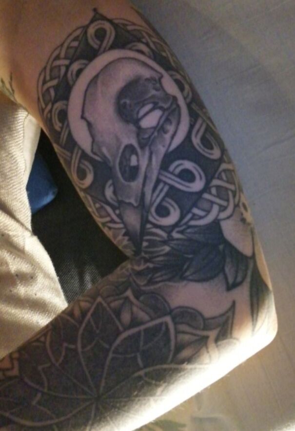 Skull and intricate pattern tattoo on arm showcasing impressive new tattoo art.