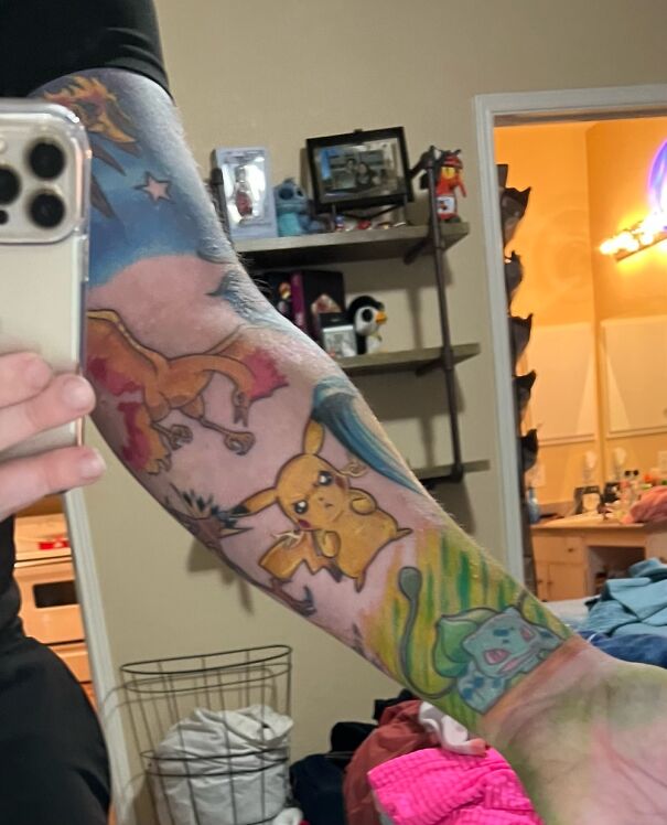 Colorful tattoo featuring Pikachu, Charizard, and Bulbasaur on a person's arm, showcasing impressive new ink art.