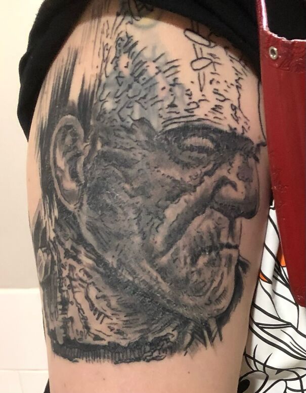 Impressive new tattoo of a detailed black and gray portrait on an arm, featuring intricate shading and line work.