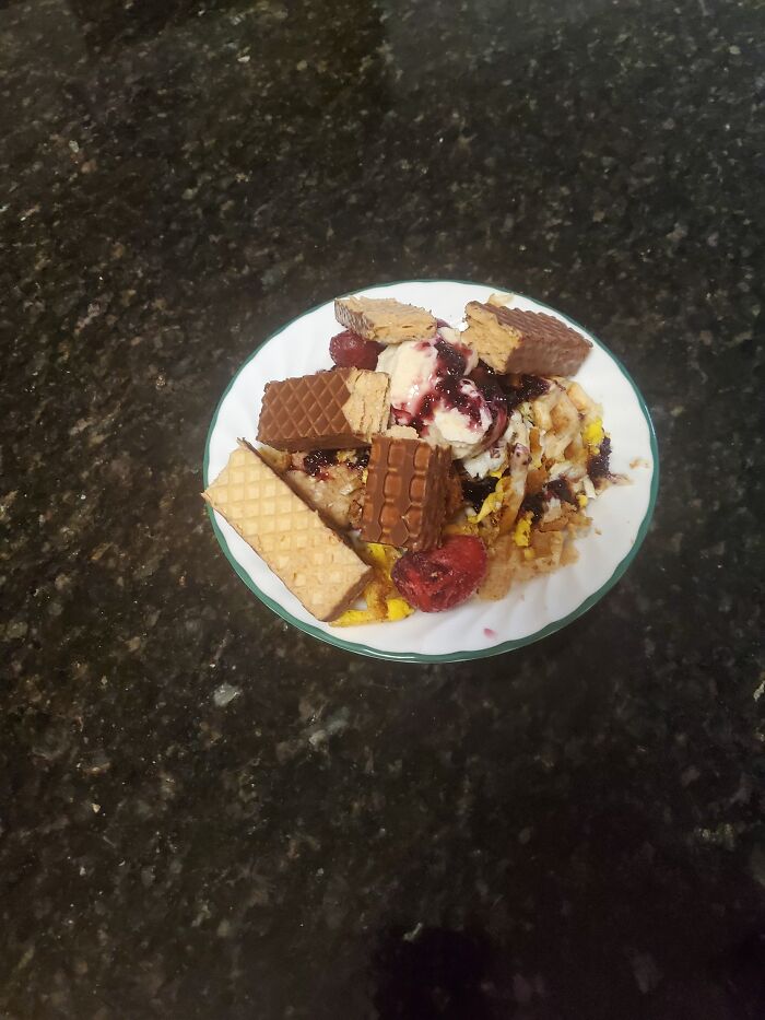 French Toast Souffle With Organic Blueberry Jam, And Vanilla Icecream With A Nutty Buddy And Some Berries On Top.