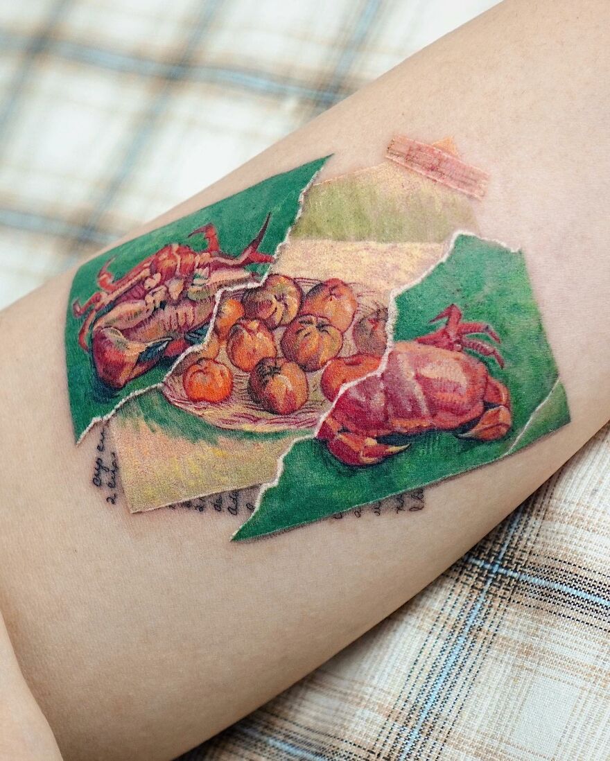 Painting-like tattoo of crabs and oranges on an arm, showcasing intricate art details.