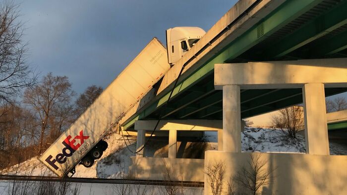 FedEx Truck Hanging Off The Indiana Toll Road After Hitting Ice In Frigid Conditions. Driver Not Hurt