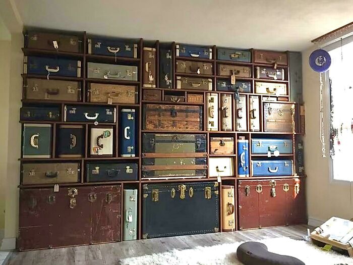 Old Trunks And Suitcases On Custom Shelves Are A Cool Storage Solution