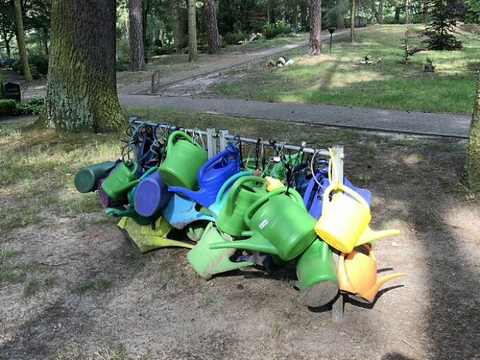 This Graveyard Rack Here Is The Most German Thing I’ve Seen So Far In 25 Years: Relatives Bring Their Own Watering Can And Lock It To A Designated “Watering Can Rack”