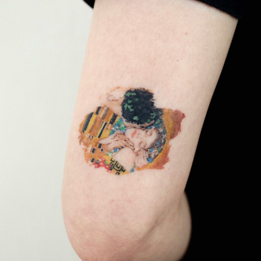 Painting-like tattoo on arm, featuring an intricate artistic design.