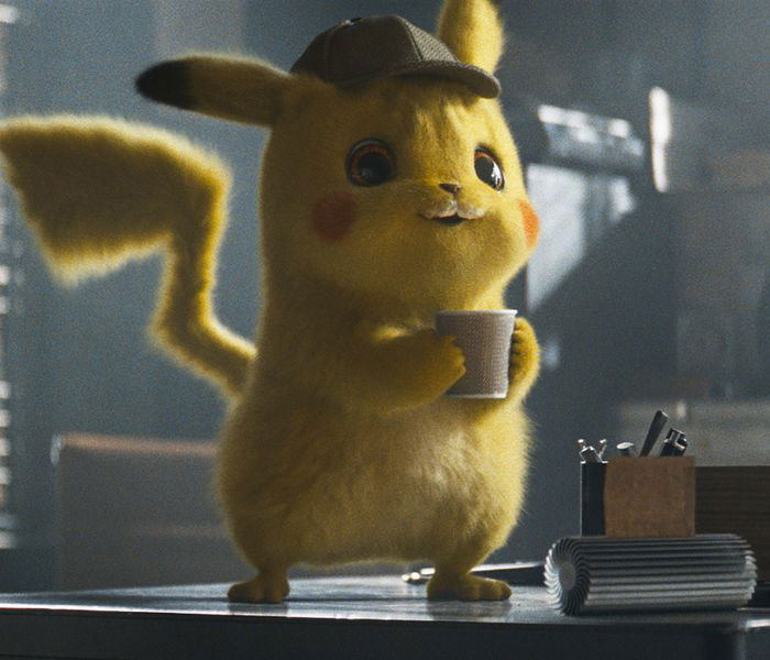 Cute animated character holding a cup, wearing a detective hat, standing on a table.