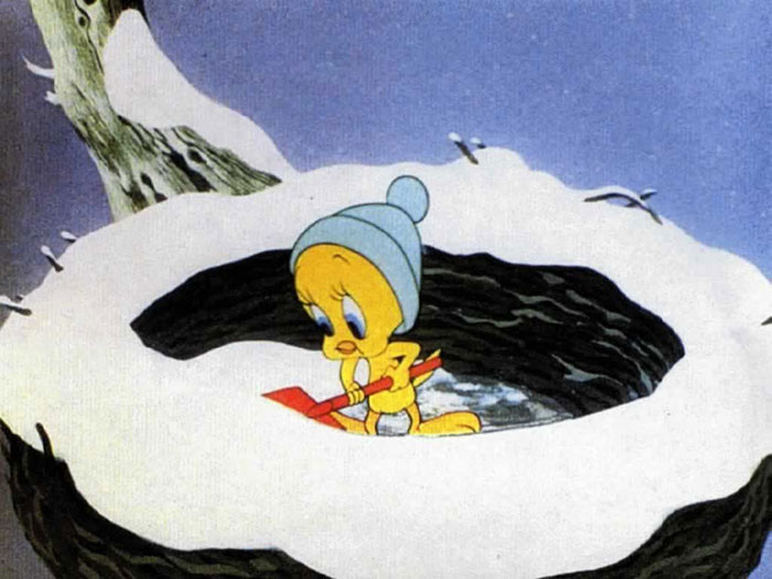 Cute animated character in a snowy nest, wearing a blue hat and holding a small red shovel.