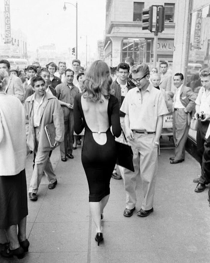Vikki Dougan Walking Through The Streets Of Hollywood In What Was Identified As A ‘Daring’ Backless Black Dress