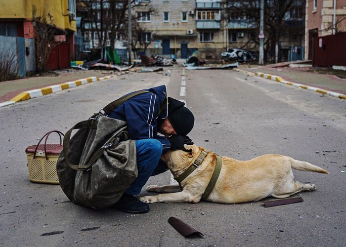 Woman Carries And Comforts Cat Amid Air Raid Sirens Sounding In Kyiv, Ukraine Woman Carries And Comforts Cat Amid Air Raid Sirens Sounding In Kyiv, Ukraine
