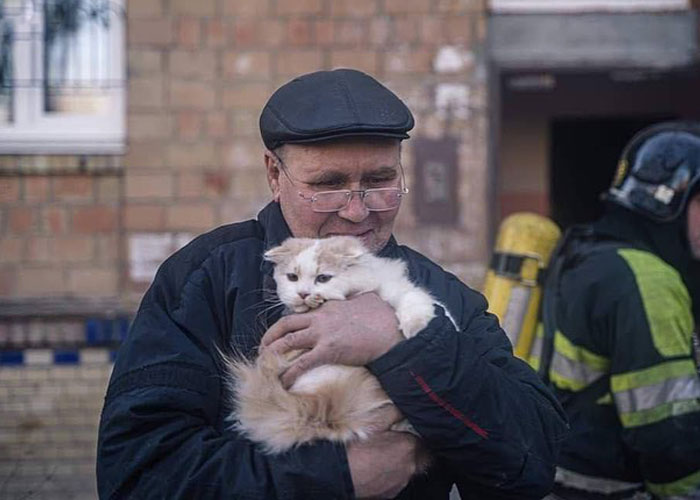 Woman Carries And Comforts Cat Amid Air Raid Sirens Sounding In Kyiv, Ukraine Woman Carries And Comforts Cat Amid Air Raid Sirens Sounding In Kyiv, Ukraine