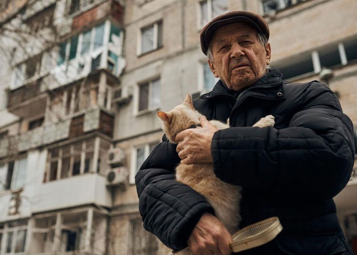 Woman Carries And Comforts Cat Amid Air Raid Sirens Sounding In Kyiv, Ukraine Woman Carries And Comforts Cat Amid Air Raid Sirens Sounding In Kyiv, Ukraine