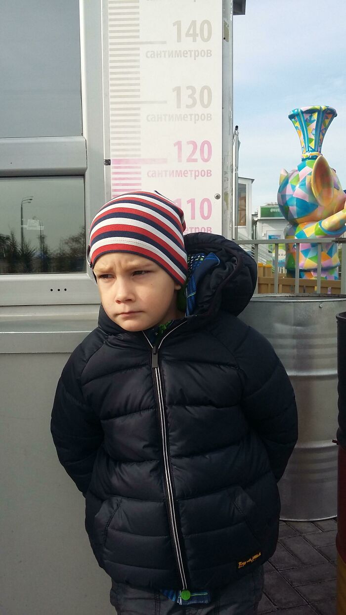 This Boy Is Upset Because He Is Not Tall Enough To Get On The Carousel In The Park