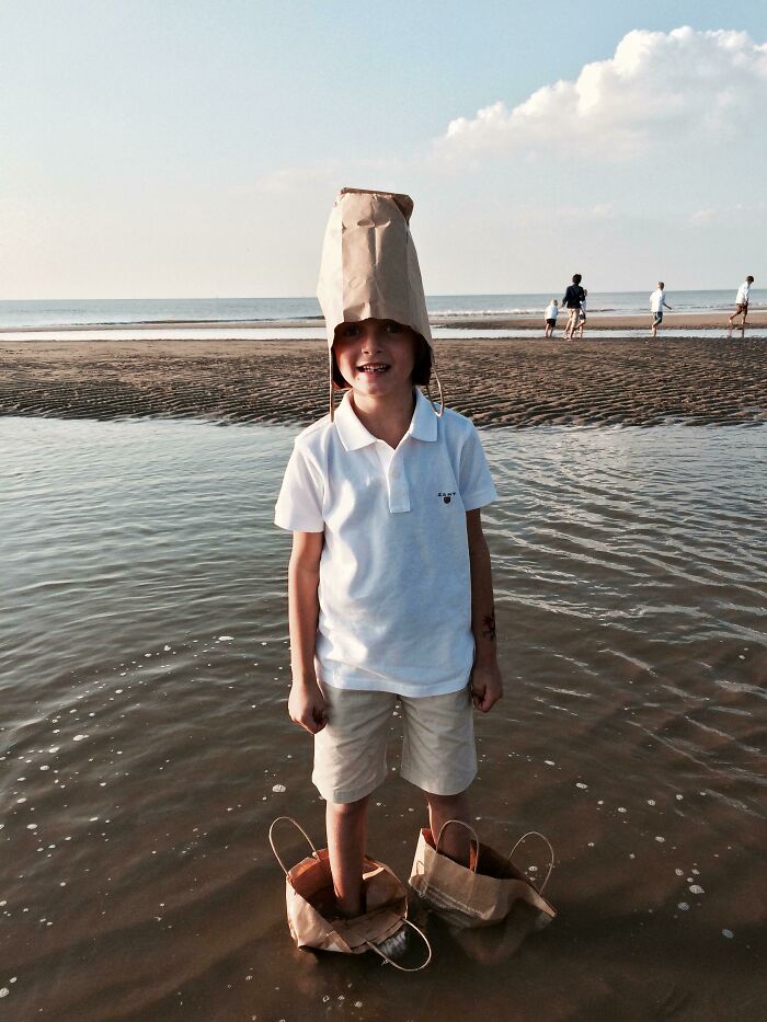 He Didn't Want His Shoes To Get Wet, So He Put Paper Bags On His Feet And Waded Into The Ocean