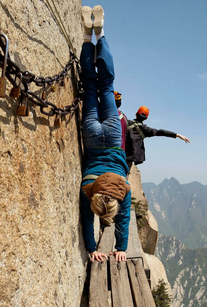 La novia de /u/Intertim haciendo una parada de manos en la ladera del monte Huashan, China