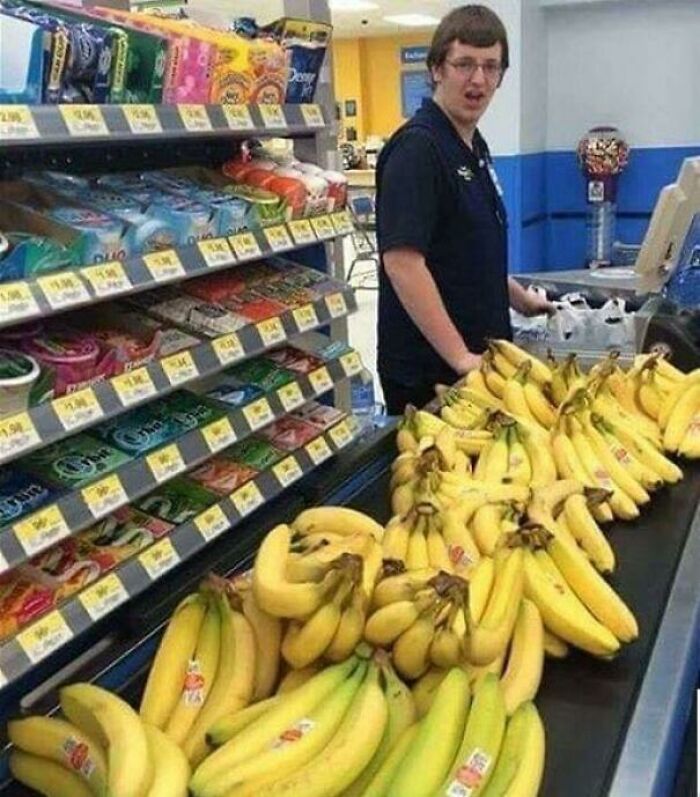 Cashier looking at many bananas 