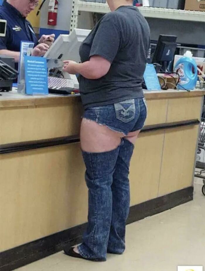Person with weird cut of jeans standing near a cash register 