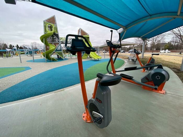 Equipamiento para hacer ejercicio en el parque, mirando al parque con columpios