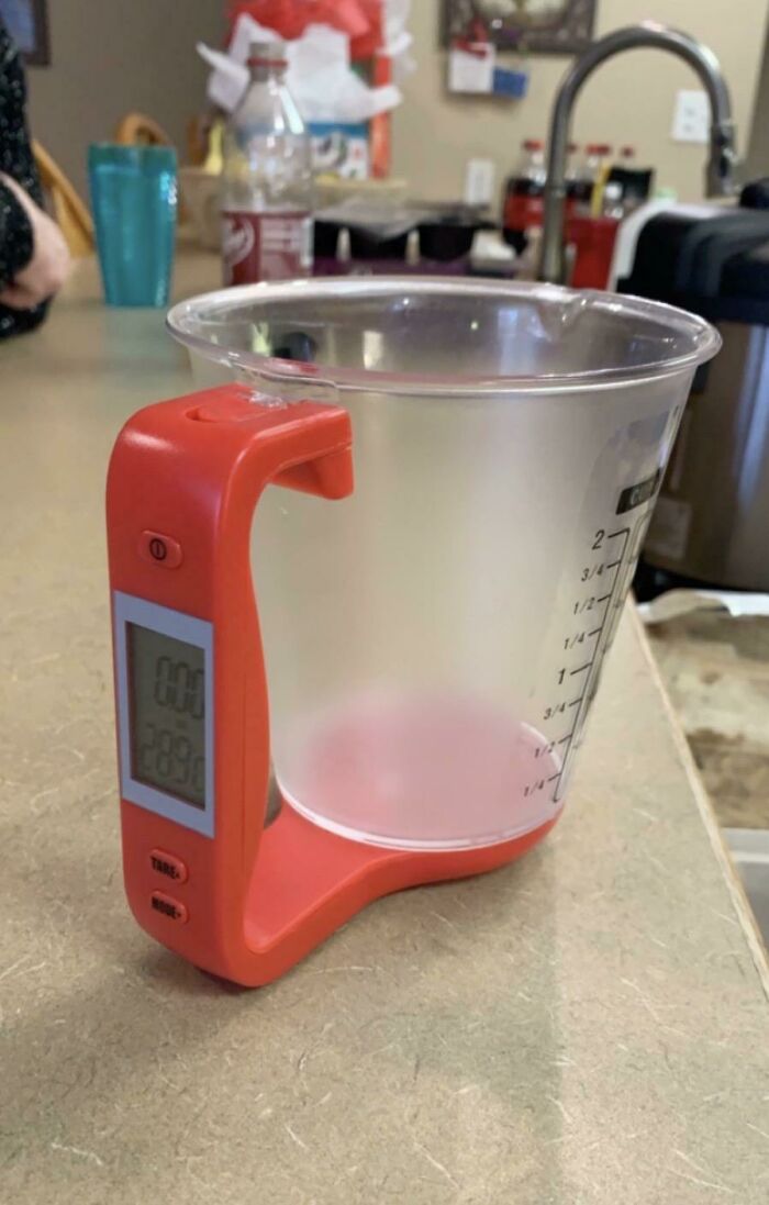 A Measuring Cup With A Built In Scale