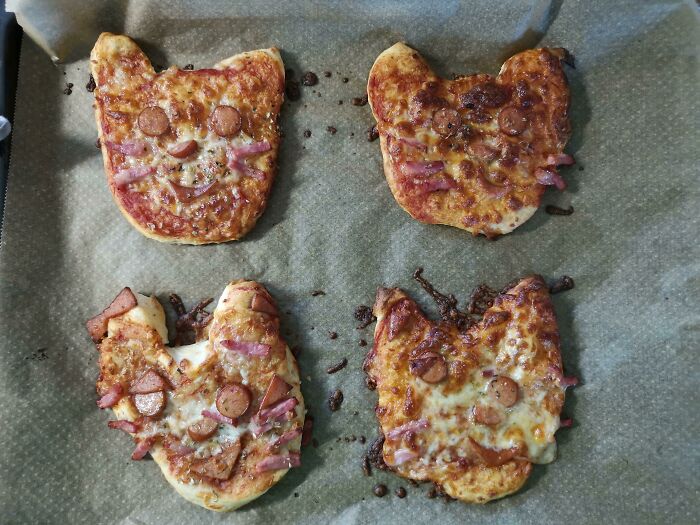 I Made Cute Little Cat Pizzas To Please Our Toddler. This Is After They Baked. They Look Like Burn Victims