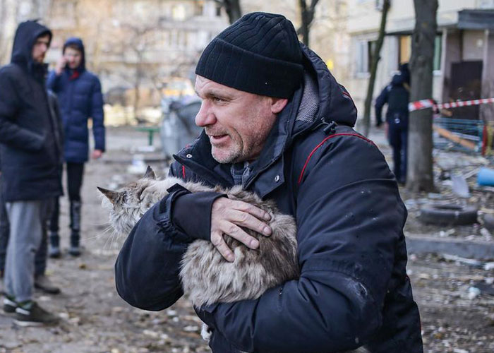 Woman Carries And Comforts Cat Amid Air Raid Sirens Sounding In Kyiv, Ukraine Woman Carries And Comforts Cat Amid Air Raid Sirens Sounding In Kyiv, Ukraine