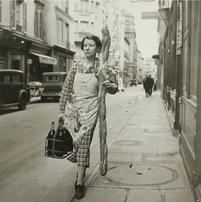 A French Woman With Her Baguette And Six Bottles Of Wine, Paris, France, 1945