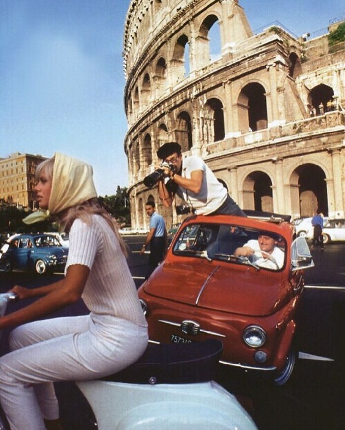 Peter Sellers Taking A Photo Of His Wife, Britt Eckland While Both Riding In Moving Vehicles | Rome, 1965