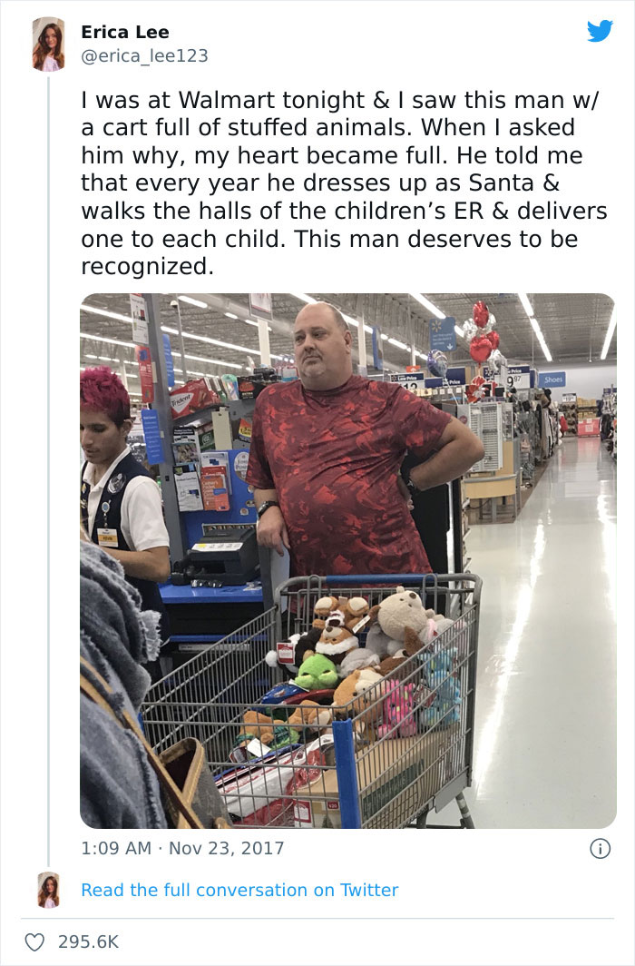 Man standing with a cart filled with plush toys 