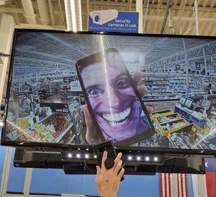 Person showing a selfie to a security camera in Walmart 