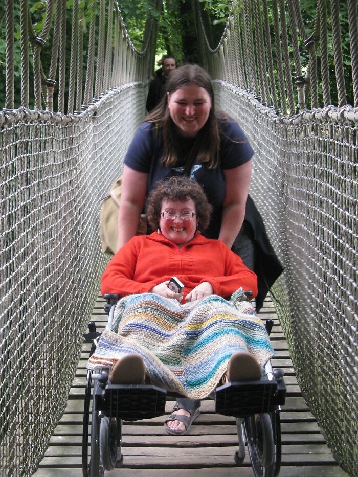 I Use The Chair Because Of Fatigue. I Could Have Walked Across The Suspension Bridge Ok, But Krissy Insisted On Pushing Me. It's Tilted Back So The Small Front Wheels Don't Catch The Planks.