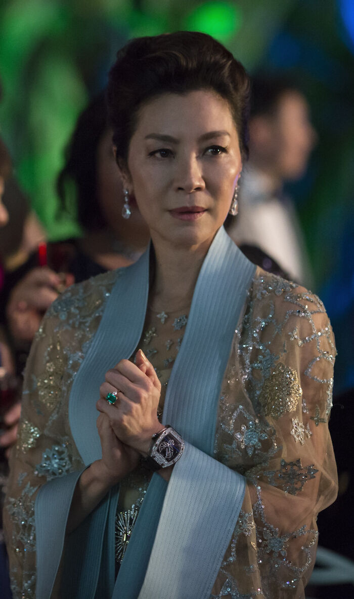 The Emerald Ring Worn By Eleanor In “Crazy Rich Asians” Is Not A Prop But An Actual Piece Owned And Designed By Michelle Yeoh. She Chose To Wear It Instead Of The One Designed By The Film’s Art Department Because She Felt It Was Truer To Her Character’s Taste