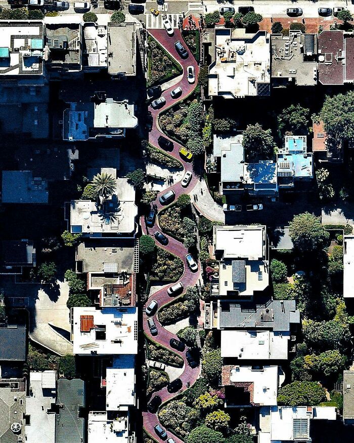 Cars Winding Down The Hill Of Lombard Street In San Francisco, California. With Eight Hairpin Turns Dispersed Over A One-Block Section In The Russian Hill Neighborhood, Lombard Is Often Referred To As “The Most Crooked Street In The World”