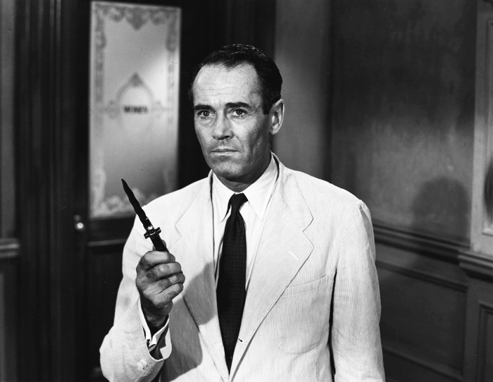 black and white photo of Henry Fonda with a knife in his hand